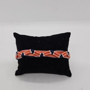 Juicy Couture light orange and blue threaded bracelet with bells
